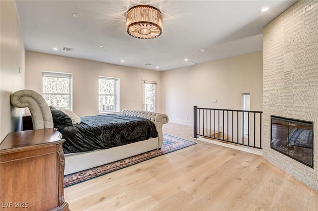 4162 Matterhorn Way, Las Vegas, NV 89124 - bedroom with wood finished floors, recessed lighting, a stone fireplace, and baseboards