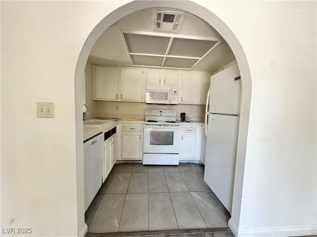 6137 W Oakey Blvd Unit A, Las Vegas, NV 89146 - kitchen with white appliances, light tile patterned floors, light countertops, a sink, and white cabinets