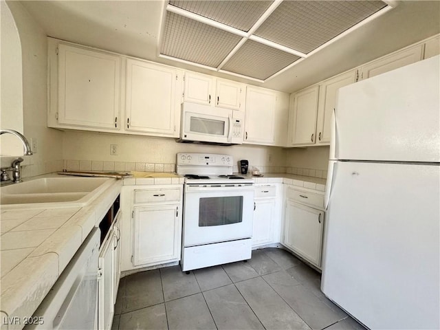 6137 W Oakey Blvd Unit A, Las Vegas, NV 89146 - kitchen featuring white appliances, a sink, tile counters, and white cabinets