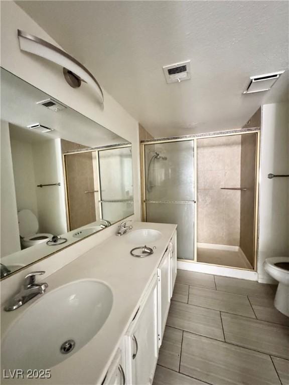 6137 W Oakey Blvd Unit A, Las Vegas, NV 89146 - bathroom featuring a stall shower, double vanity, and tile patterned flooring