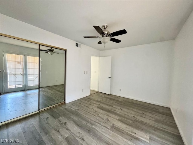 6137 W Oakey Blvd Unit A, Las Vegas, NV 89146 - unfurnished bedroom featuring wood finished floors, baseboards, a closet, and ceiling fan