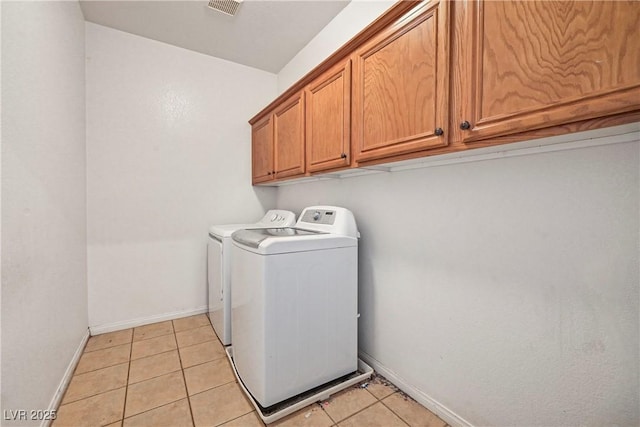 7821 Red Leaf Dr, Las Vegas, NV 89131 - laundry room featuring separate washer and dryer, cabinet space, and light tile patterned floors
