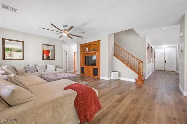 7821 Red Leaf Dr, Las Vegas, NV 89131 - living area with ceiling fan, stairs, and wood finished floors