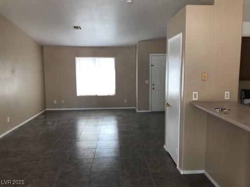 4704 Wild Oak Way N, Las Vegas, NV 89031 - unfurnished dining area with dark tile patterned floors and baseboards