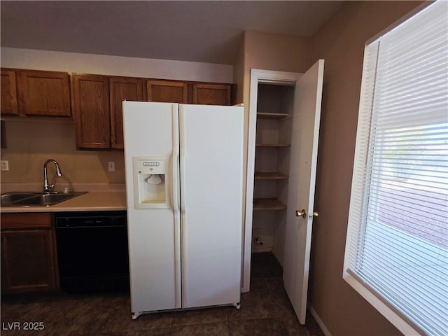 4704 Wild Oak Way N, Las Vegas, NV 89031 - kitchen with white fridge with ice dispenser, black dishwasher, plenty of natural light, and light countertops