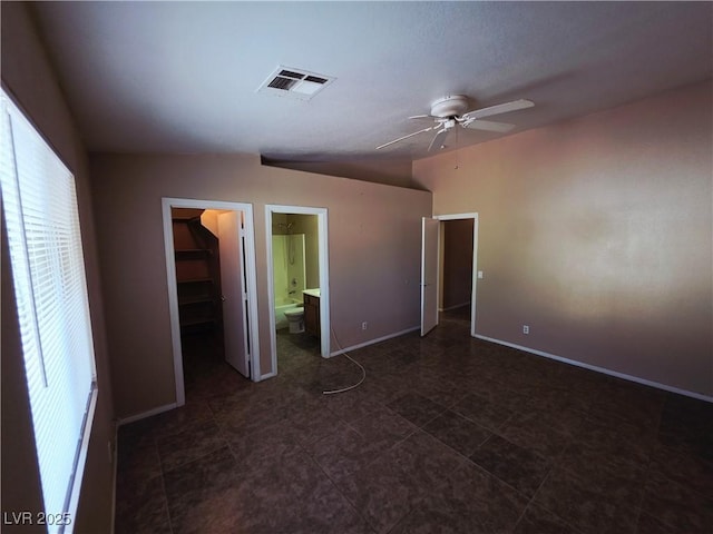 4704 Wild Oak Way N, Las Vegas, NV 89031 - unfurnished bedroom with a walk in closet, lofted ceiling, connected bathroom, ceiling fan, and a closet