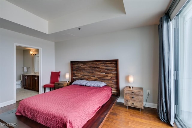 150 Las Vegas Blvd Unit 2115, Las Vegas, NV 89101 - bedroom with light wood-style floors, baseboards, and ensuite bath