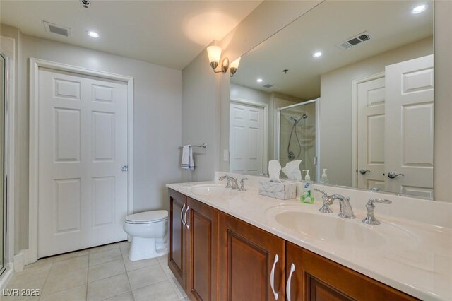 150 Las Vegas Blvd Unit 2115, Las Vegas, NV 89101 - bathroom featuring a shower stall, double vanity, toilet, tile patterned floors, and recessed lighting