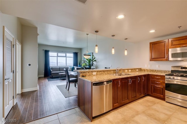 150 Las Vegas Blvd Unit 2115, Las Vegas, NV 89101 - kitchen featuring stainless steel appliances, a sink, light stone counters, a peninsula, and open floor plan