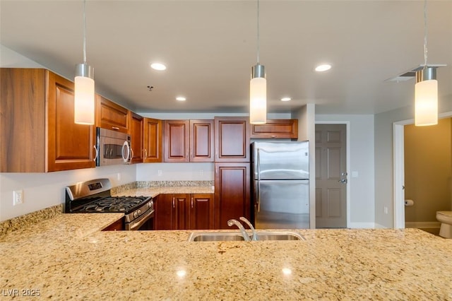 150 Las Vegas Blvd Unit 2115, Las Vegas, NV 89101 - kitchen with appliances with stainless steel finishes, a sink, light stone counters, hanging light fixtures, and recessed lighting