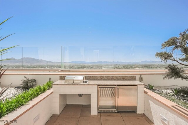 150 Las Vegas Blvd Unit 2115, Las Vegas, NV 89101 - view of patio featuring an outdoor kitchen and a mountain view