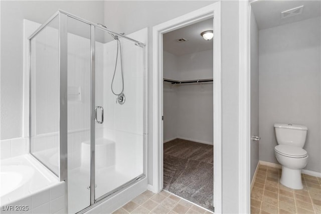7345 Chesapeake Cove St, Las Vegas, NV 89166 - bathroom featuring a stall shower, a walk in closet, a garden tub, and toilet