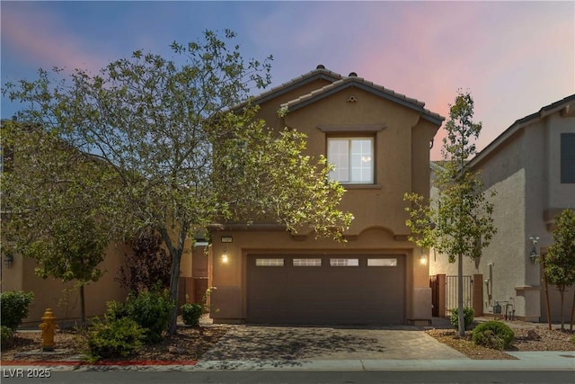 7345 Chesapeake Cove St, Las Vegas, NV 89166 - view of front of home featuring an attached garage, driveway, stucco siding, and a tiled roof
