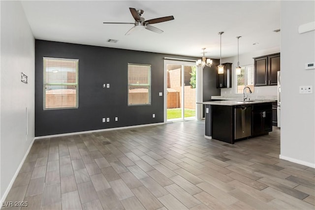 7345 Chesapeake Cove St, Las Vegas, NV 89166 - kitchen with open floor plan, light countertops, a ceiling fan, a kitchen island with sink, and stainless steel dishwasher