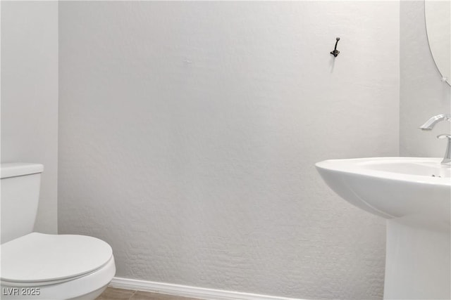 7345 Chesapeake Cove St, Las Vegas, NV 89166 - bathroom with toilet and baseboards