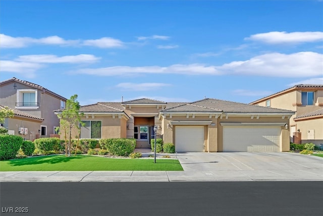 2410 Sunburst View St, Henderson, NV 89052 - view of front of property featuring an attached garage, concrete driveway, stucco siding, a tiled roof, and a front lawn