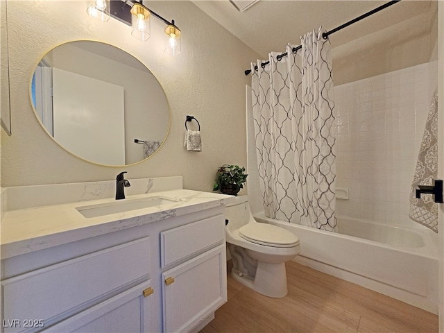 6853 Tamarus St Unit 202, Las Vegas, NV 89119 - full bathroom featuring toilet, wood finished floors, shower / bath combo with shower curtain, vanity, and a textured wall