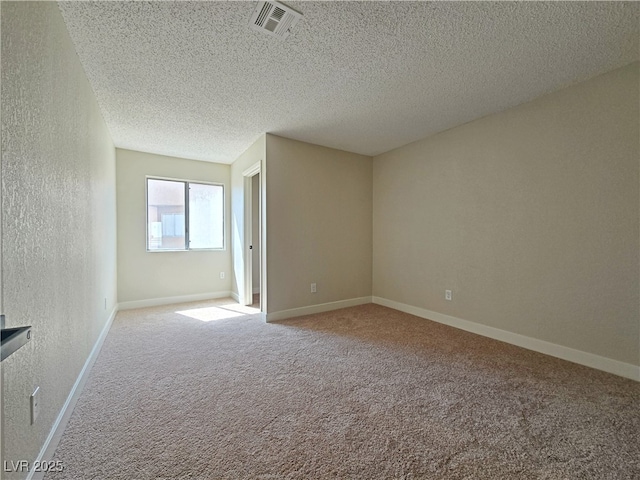 6853 Tamarus St Unit 202, Las Vegas, NV 89119 - empty room featuring a textured wall, a textured ceiling, carpet, and baseboards