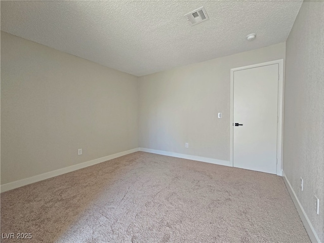 6853 Tamarus St Unit 202, Las Vegas, NV 89119 - empty room with carpet floors, a textured ceiling, a smoke detector, and baseboards