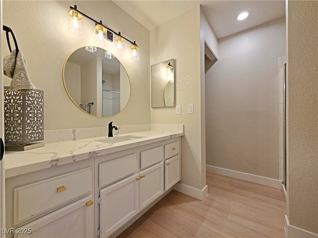 6853 Tamarus St Unit 202, Las Vegas, NV 89119 - full bath featuring wood finished floors, vanity, and baseboards