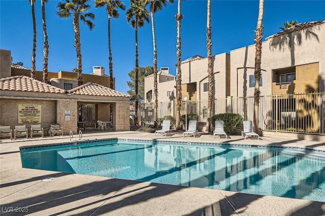 6853 Tamarus St Unit 202, Las Vegas, NV 89119 - community pool with a patio area and a residential view