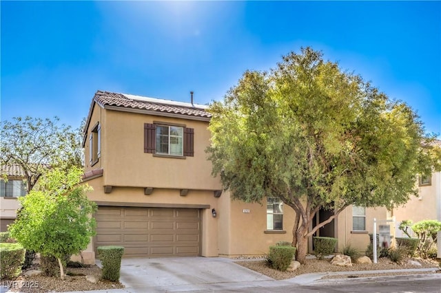 5232 Pendergrass St, North Las Vegas, NV 89081 - view of front of property featuring a tile roof, stucco siding, concrete driveway, and an attached garage