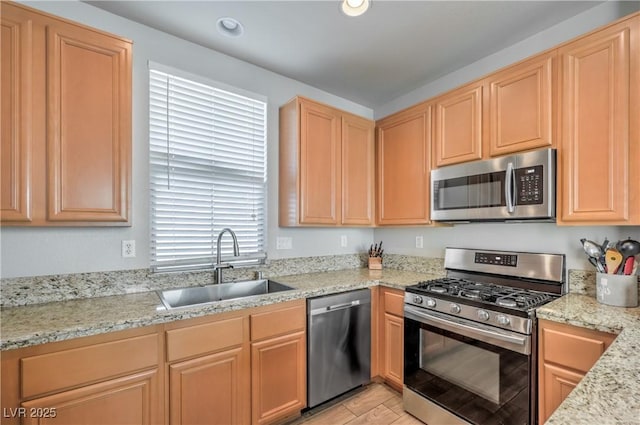 5232 Pendergrass St, North Las Vegas, NV 89081 - kitchen featuring appliances with stainless steel finishes, a sink, light brown cabinetry, light stone countertops, and recessed lighting