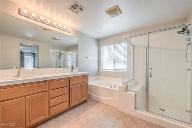 5232 Pendergrass St, North Las Vegas, NV 89081 - bathroom with a bath, a stall shower, tile patterned floors, and double vanity
