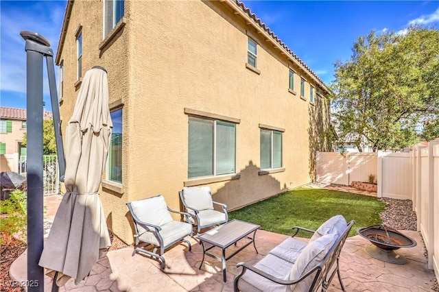 5232 Pendergrass St, North Las Vegas, NV 89081 - back of house featuring a fire pit, stucco siding, a patio, a fenced backyard, and a tiled roof