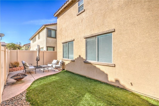 5232 Pendergrass St, North Las Vegas, NV 89081 - back of house featuring an outdoor fire pit, a patio, and stucco siding