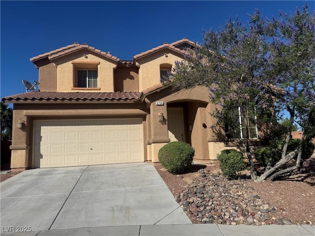 6756 Sea Swallow St, North Las Vegas, NV 89084 - mediterranean / spanish home featuring concrete driveway, stucco siding, a tile roof, and a garage