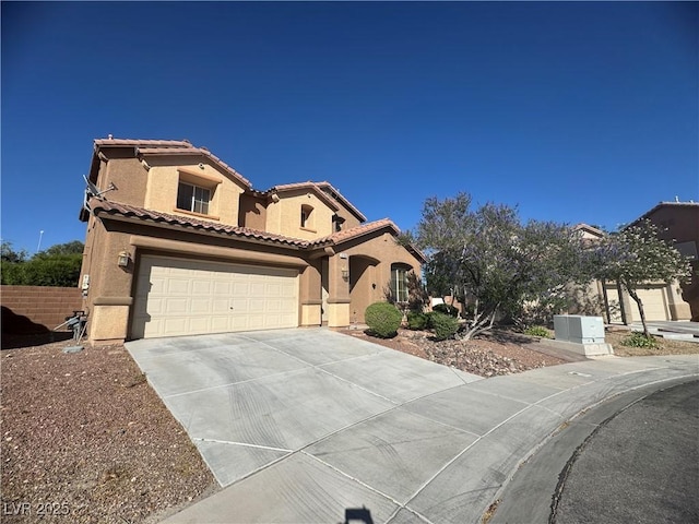 6756 Sea Swallow St, North Las Vegas, NV 89084 - mediterranean / spanish house featuring concrete driveway, stucco siding, a tiled roof, and an attached garage