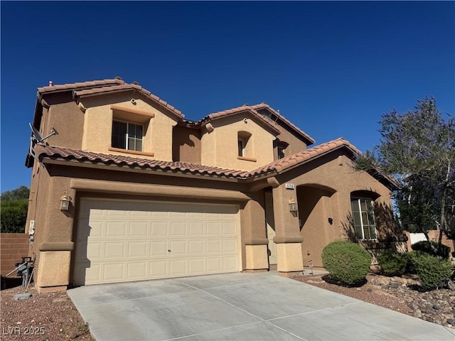 6756 Sea Swallow St, North Las Vegas, NV 89084 - mediterranean / spanish-style home with concrete driveway, stucco siding, a tiled roof, and a garage