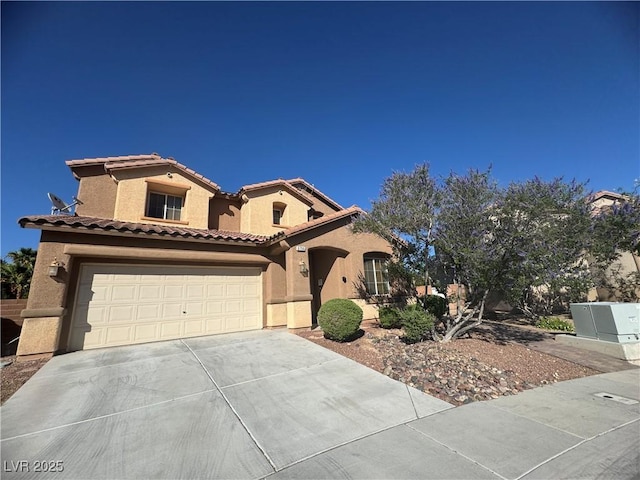 6756 Sea Swallow St, North Las Vegas, NV 89084 - mediterranean / spanish house featuring driveway, stucco siding, a tiled roof, and a garage