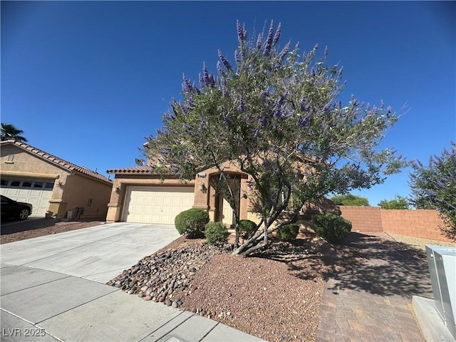 6756 Sea Swallow St, North Las Vegas, NV 89084 - view of front of house with a garage, concrete driveway, stucco siding, and a tiled roof