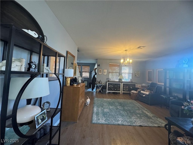 6756 Sea Swallow St, North Las Vegas, NV 89084 - living room featuring a chandelier and wood finished floors