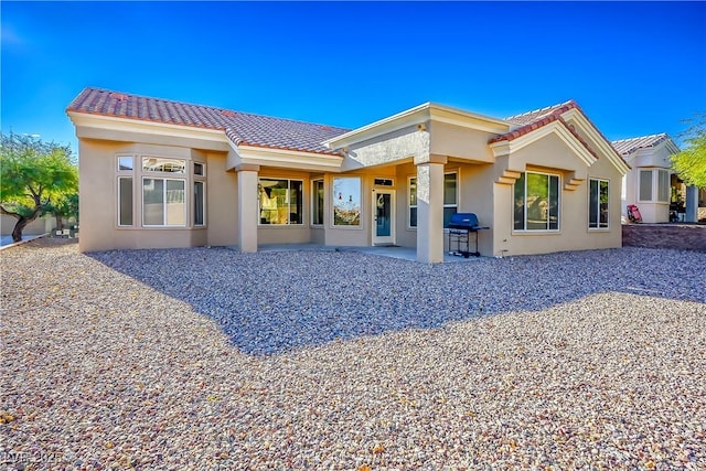 10628 Mission Lakes Ave, Las Vegas, NV 89134 - back of property featuring a tile roof, stucco siding, and a patio area
