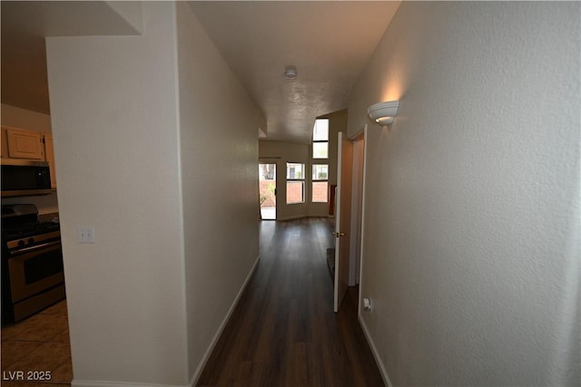 5125 W Reno Ave Unit 1059, Las Vegas, NV 89118 - hallway featuring baseboards and dark wood-style flooring