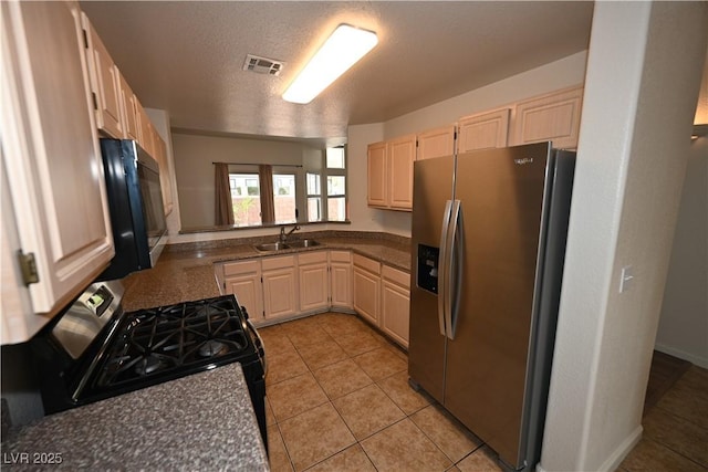 5125 W Reno Ave Unit 1059, Las Vegas, NV 89118 - kitchen with appliances with stainless steel finishes, light brown cabinets, a sink, light tile patterned floors, and dark countertops