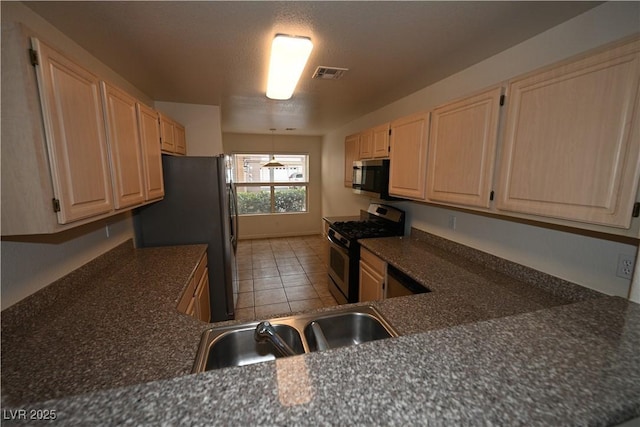 5125 W Reno Ave Unit 1059, Las Vegas, NV 89118 - kitchen featuring appliances with stainless steel finishes, light brown cabinets, light tile patterned floors, and a sink