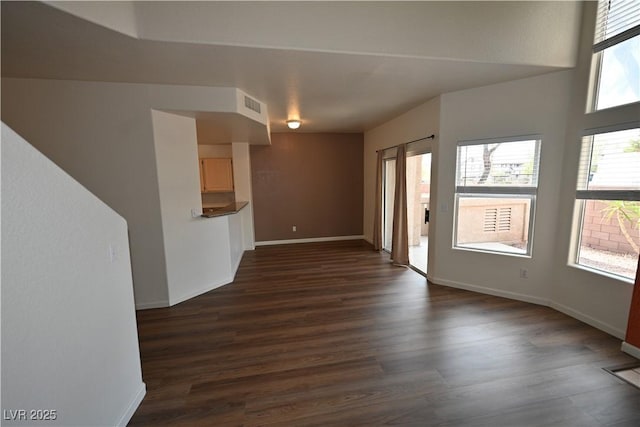 5125 W Reno Ave Unit 1059, Las Vegas, NV 89118 - unfurnished living room featuring dark wood finished floors and baseboards