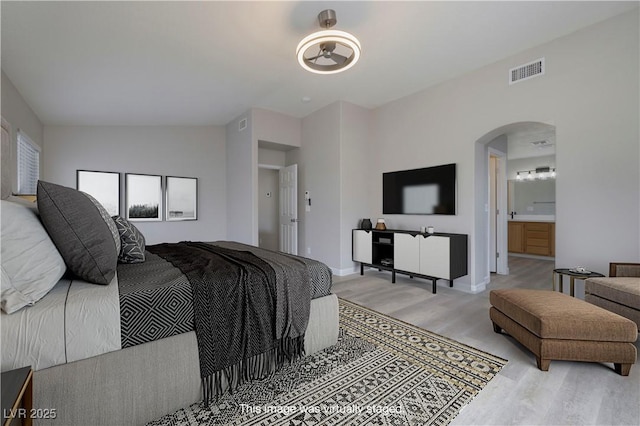 7836 Pinnochio Ave, Las Vegas, NV 89131 - bedroom featuring light wood-style floors, arched walkways, and baseboards
