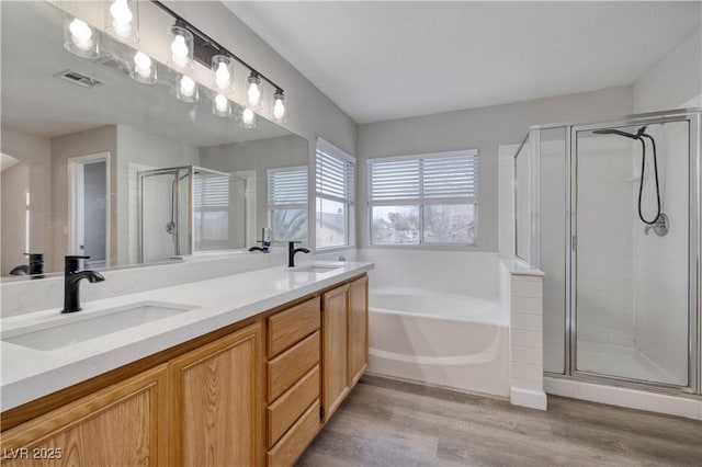 7836 Pinnochio Ave, Las Vegas, NV 89131 - full bath featuring a shower stall, a bath, double vanity, and wood finished floors