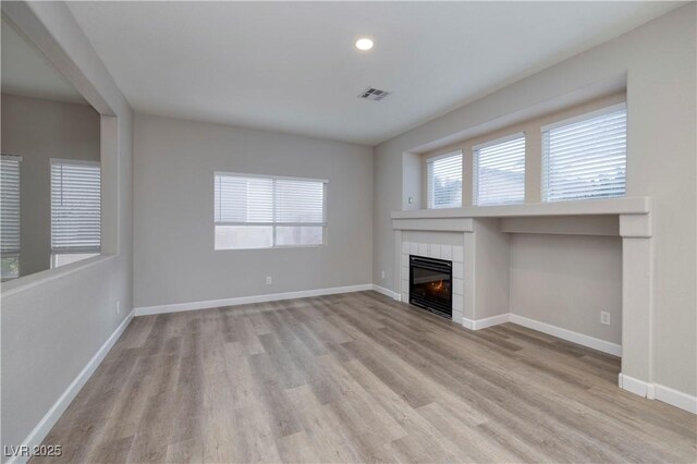 7836 Pinnochio Ave, Las Vegas, NV 89131 - unfurnished living room featuring light wood-style flooring, baseboards, a fireplace, and recessed lighting