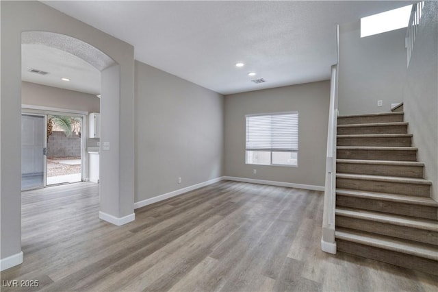 7836 Pinnochio Ave, Las Vegas, NV 89131 - unfurnished living room featuring wood finished floors, baseboards, stairway, and recessed lighting