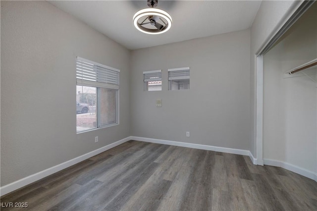 7836 Pinnochio Ave, Las Vegas, NV 89131 - unfurnished bedroom featuring dark wood-style flooring, baseboards, a closet, and a ceiling fan