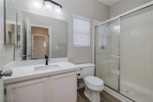 7836 Pinnochio Ave, Las Vegas, NV 89131 - bathroom featuring toilet, a shower stall, vanity, and wood finished floors