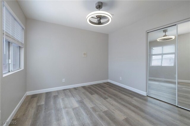7836 Pinnochio Ave, Las Vegas, NV 89131 - spare room featuring wood finished floors, a ceiling fan, and baseboards