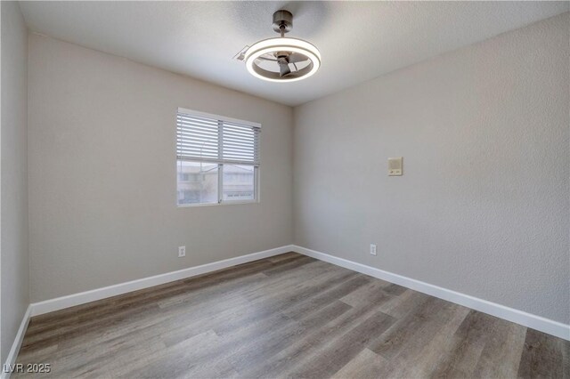 7836 Pinnochio Ave, Las Vegas, NV 89131 - unfurnished room with wood finished floors, baseboards, and a ceiling fan