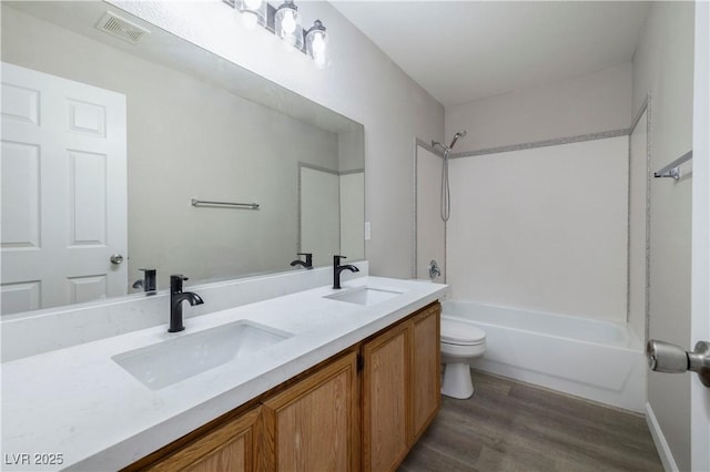 7836 Pinnochio Ave, Las Vegas, NV 89131 - full bathroom with toilet, double vanity, shower / bathtub combination, and wood finished floors